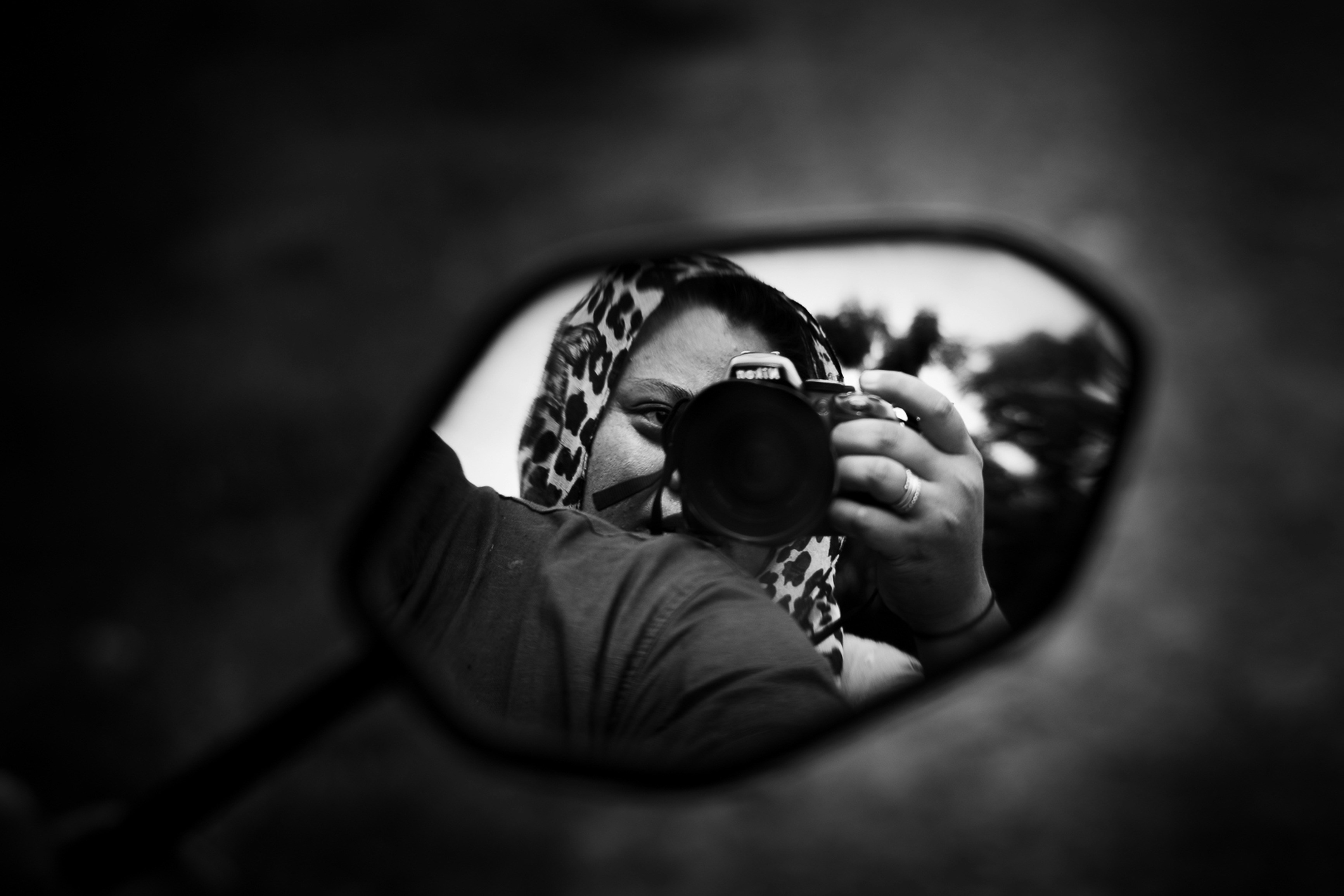 grayscale photo of woman wearing sunglasses and long sleeve shirt