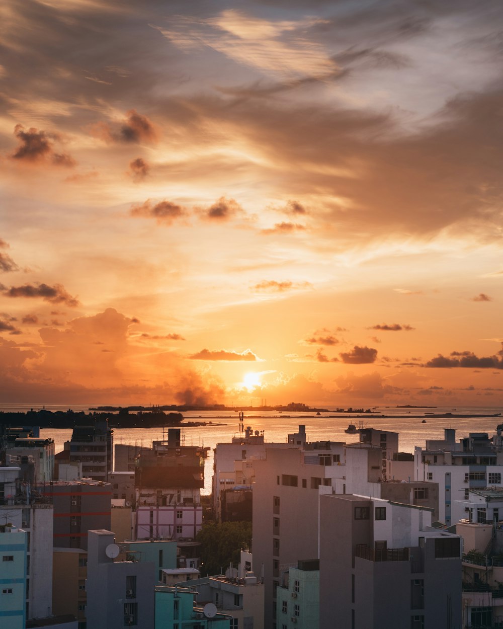 white and brown concrete buildings under cloudy sky during sunset