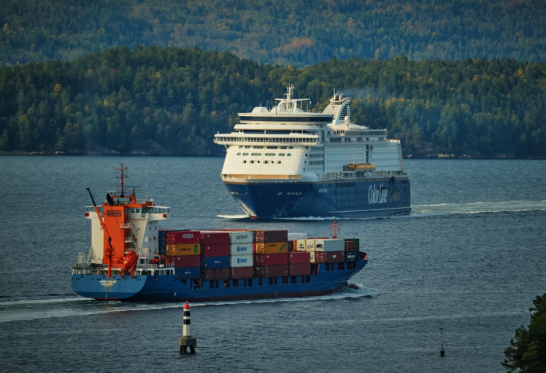 blue and white ship on sea during daytime