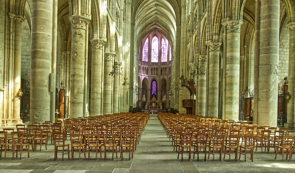 brown wooden chairs inside cathedral
