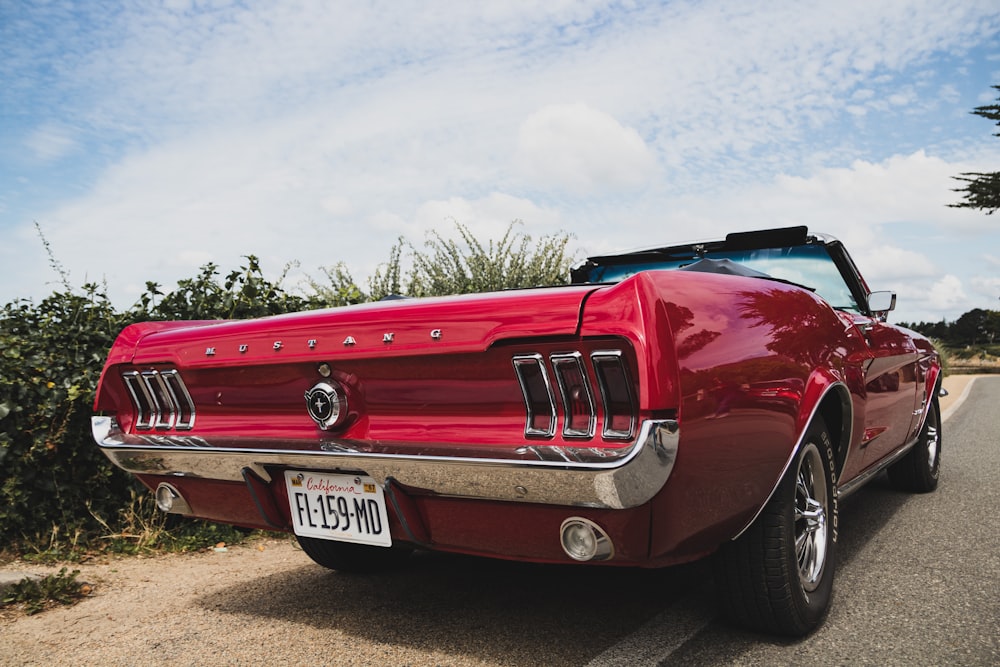 red chevrolet camaro on road during daytime