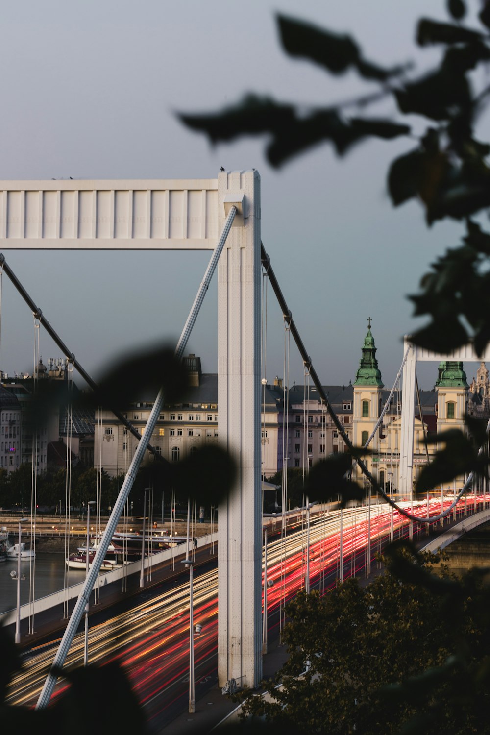 white and red bridge over river during daytime