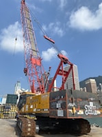 A sleek luffing jib crane maneuvering in tight spaces at a downtown development project.