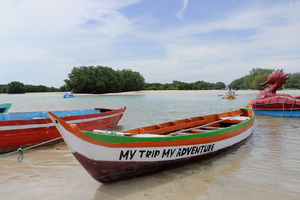 red and white boat on beach during daytime