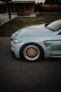 A sleek silver car parked in front of the Detling Aerodrome Estate office on a sunny day