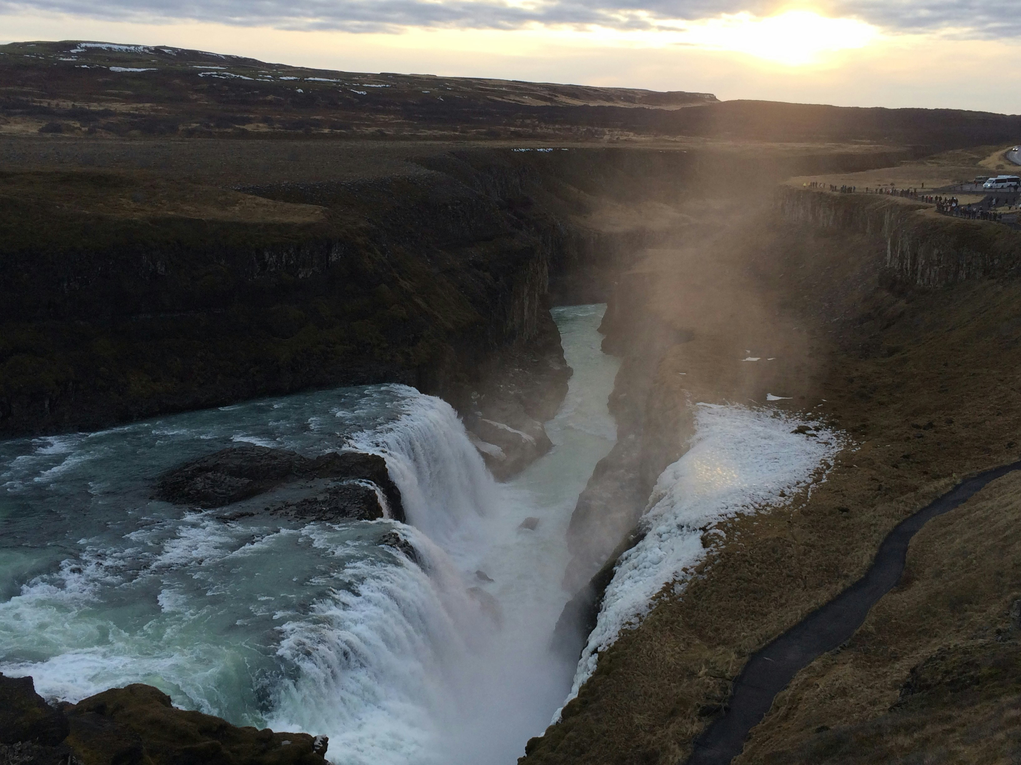 water falls under cloudy sky during daytime