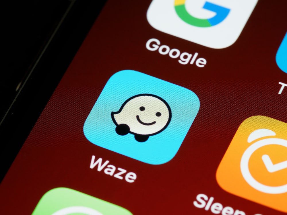 smartphone with the logo of Waze, a digital product that uses personalisation of sound design.