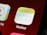 Close-up view of a smartphone screen displaying app icons, specifically the 'Notes' app with a notepad-like design and part of the 'Contacts' app icon visible.