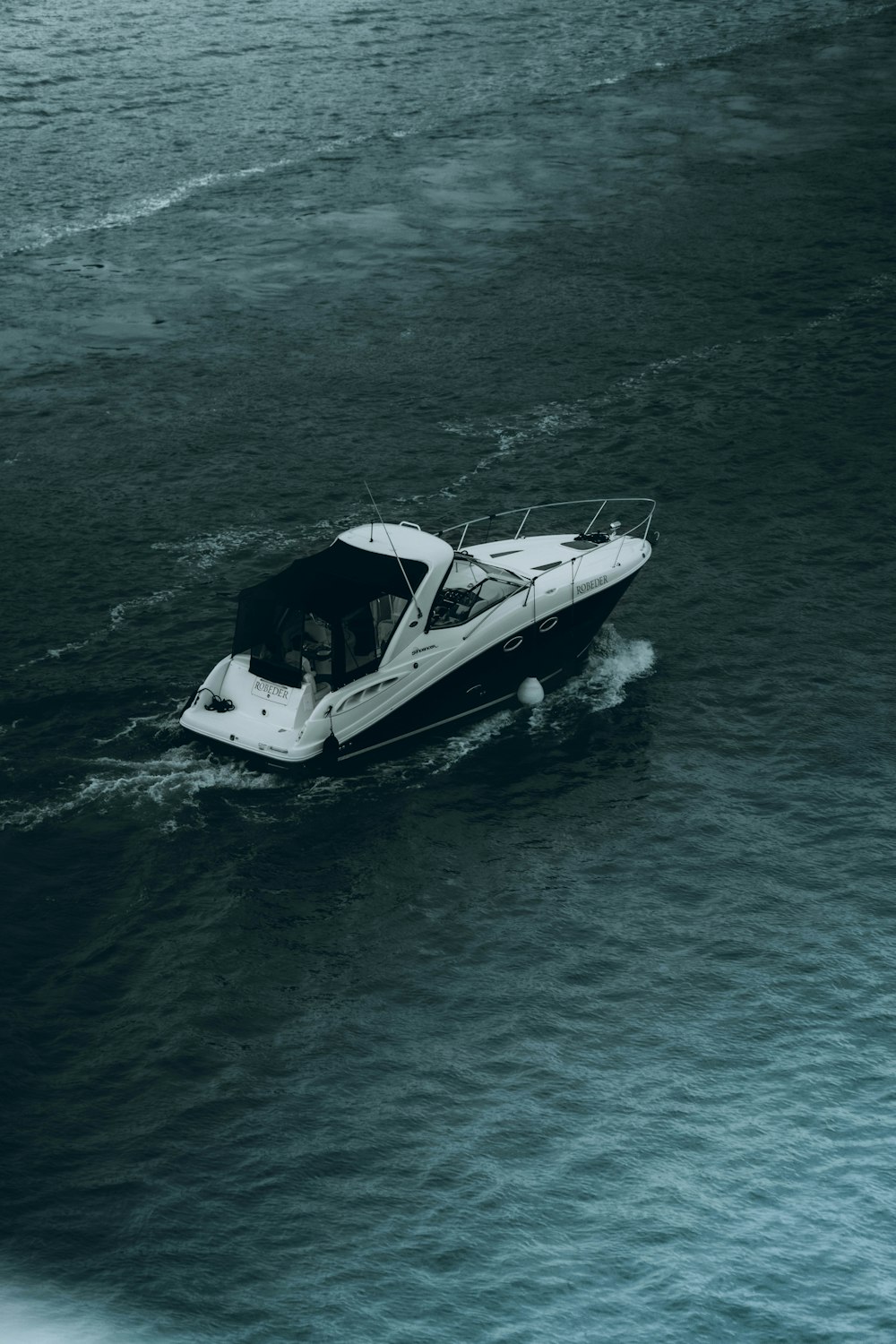 white and black yacht on sea during daytime