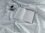An open film script with notes and a coffee cup.