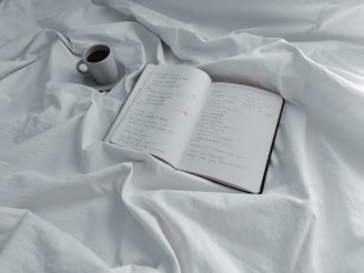 An open notebook with brainstorming ideas and a coffee cup.
