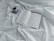 A close-up of an open book with handwritten notes and a cup of coffee beside it.