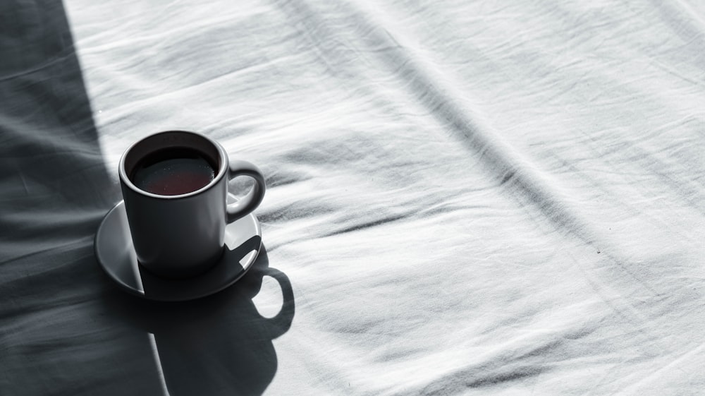 white ceramic mug on white ceramic saucer