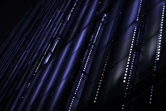 a sleek neon-blue glowing digital grid on a deep charcoal background