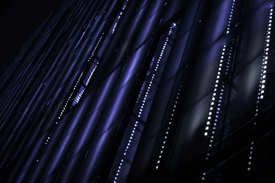 Futuristic dark-themed 3D grid with glowing blue and violet neon lines representing digital growth.