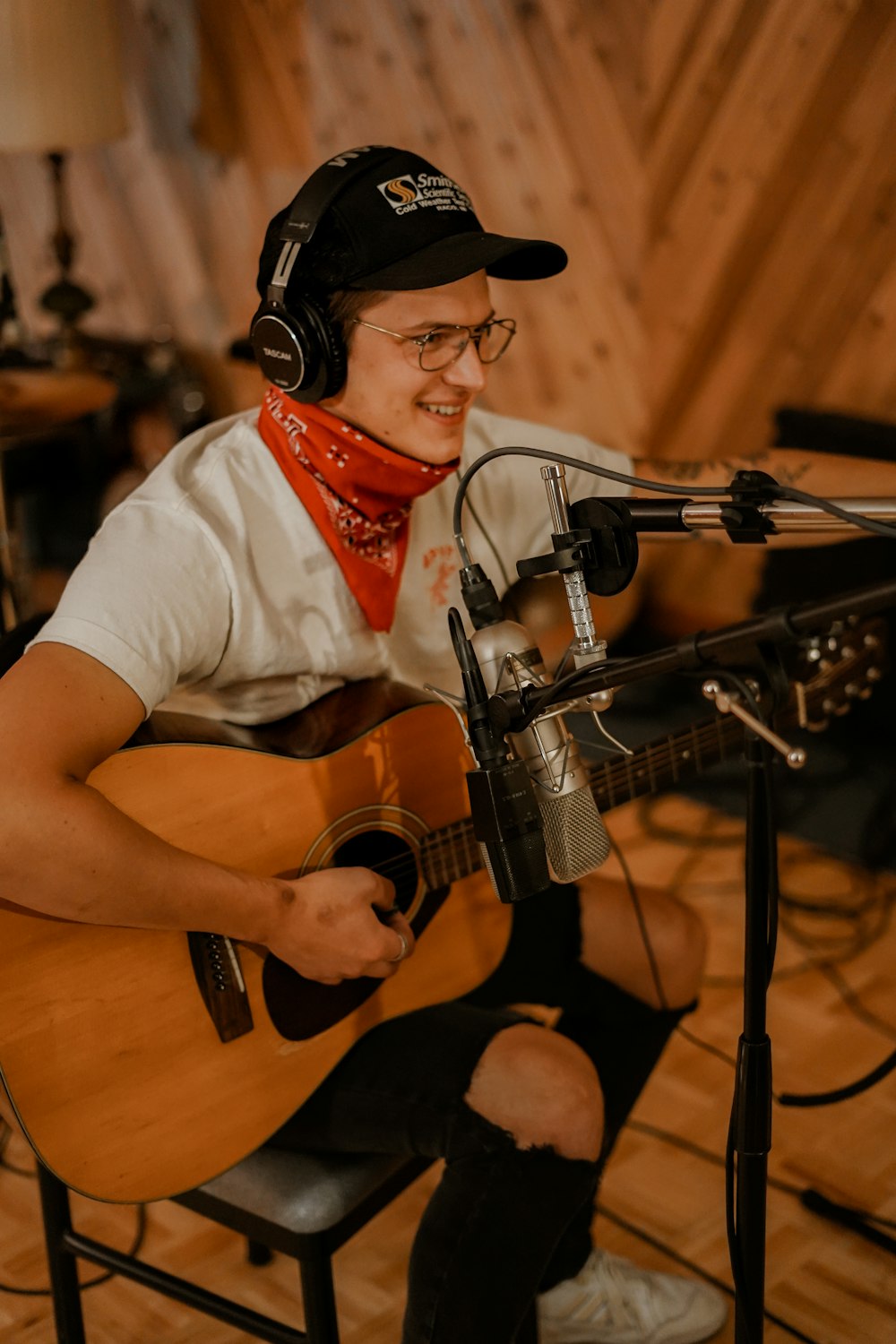 man in white button up shirt playing brown acoustic guitar