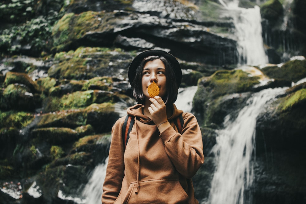 woman in brown leather jacket eating ice cream