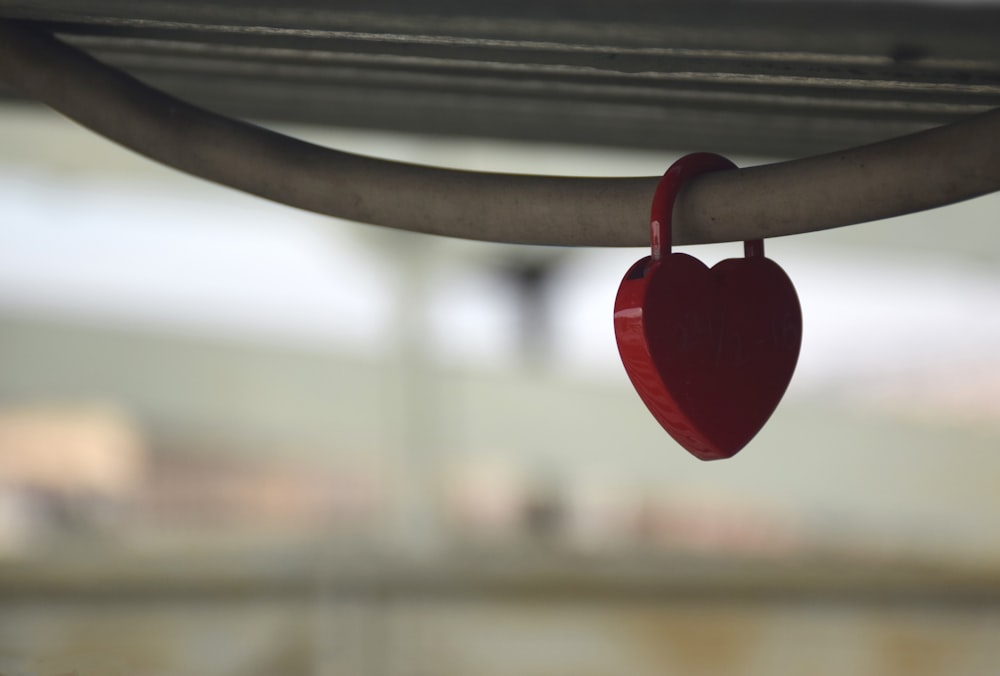 red heart hanging on black metal bar