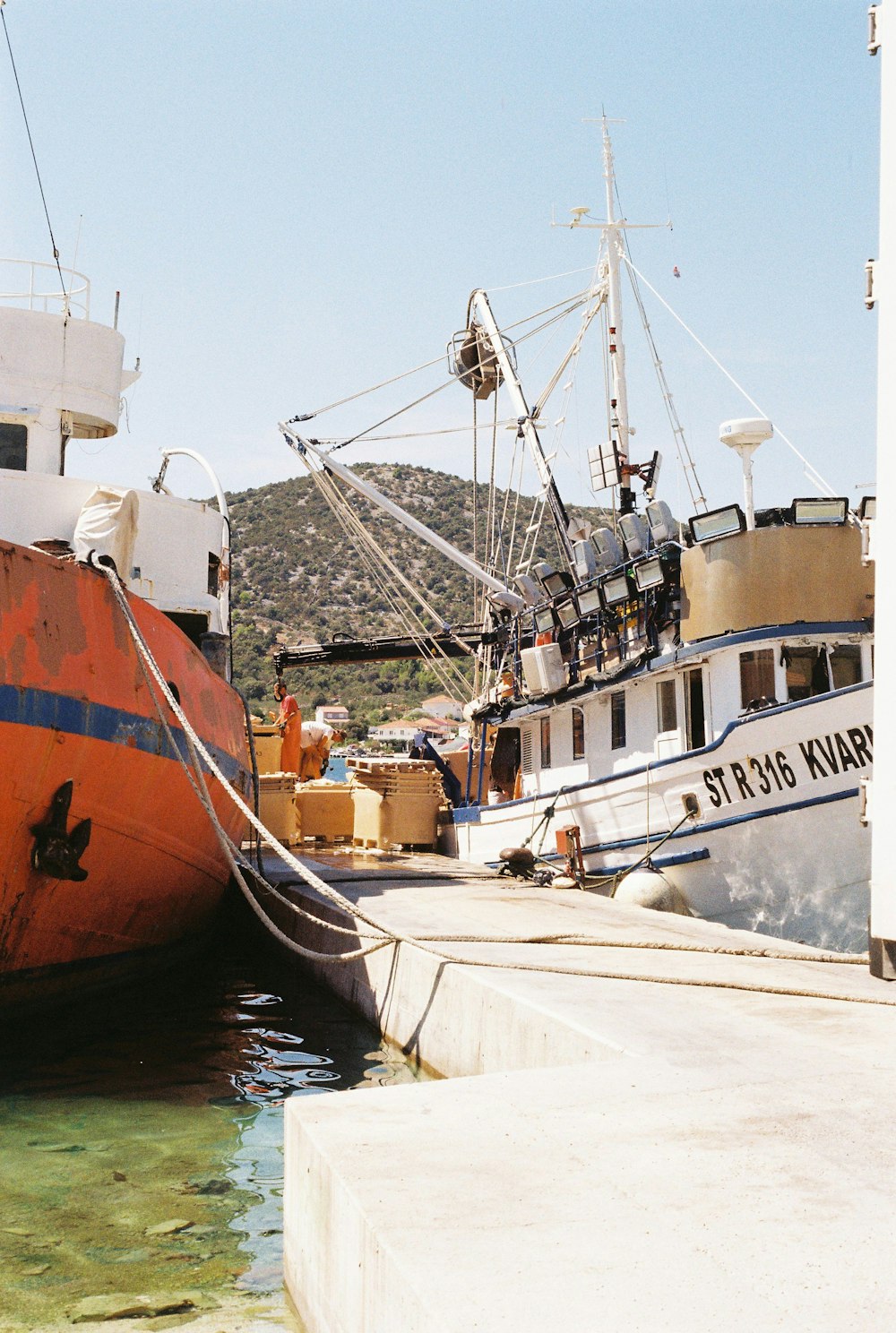 white and brown boat on dock during daytime