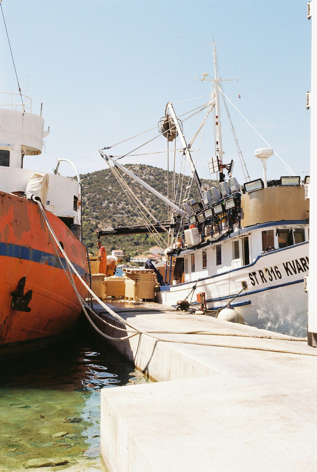 white and brown boat on dock during daytime