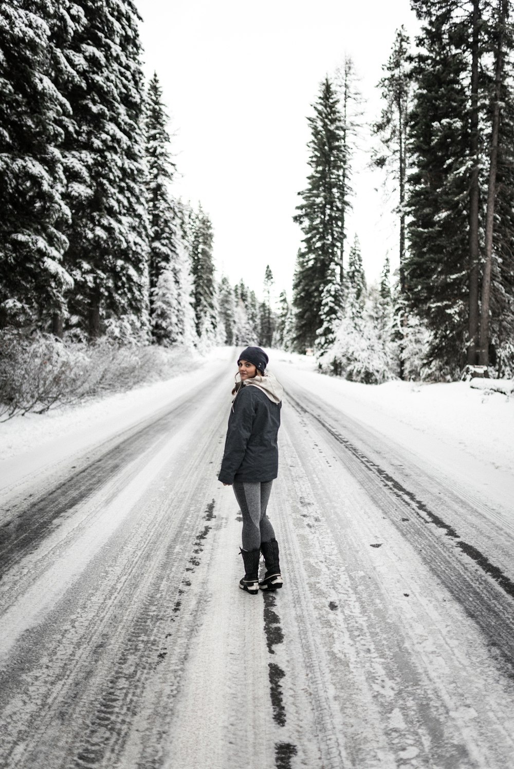 person in blue jacket walking on road during daytime