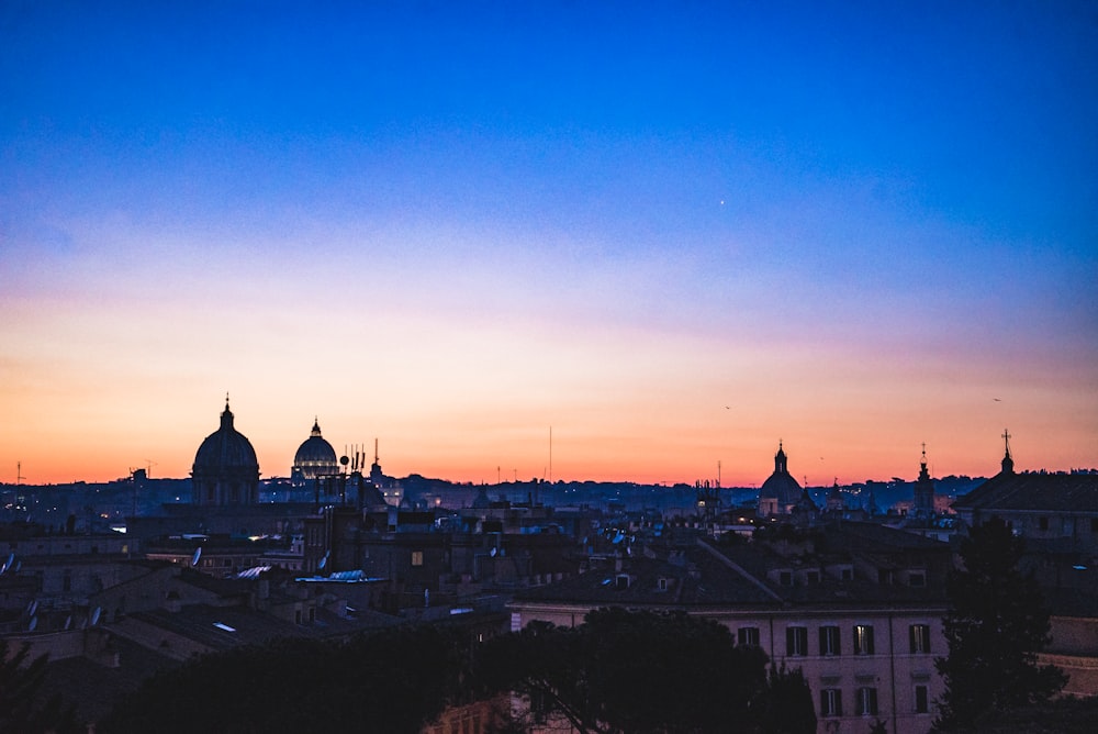 city with high rise buildings during sunset