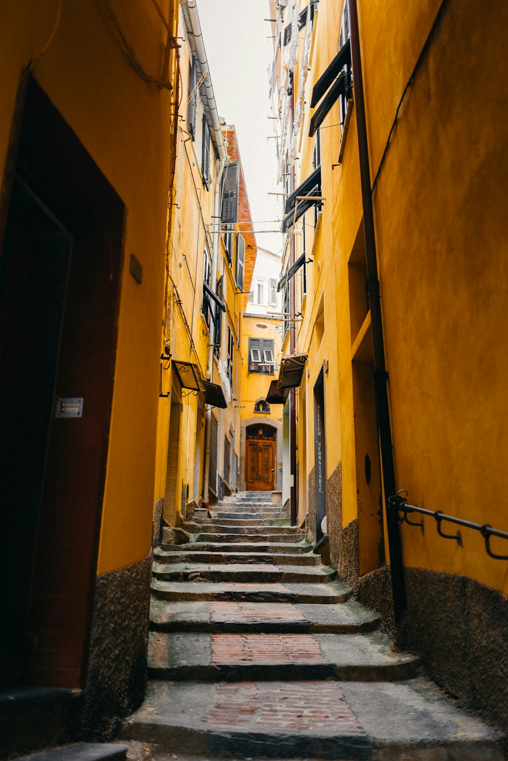 yellow painted building with staircase