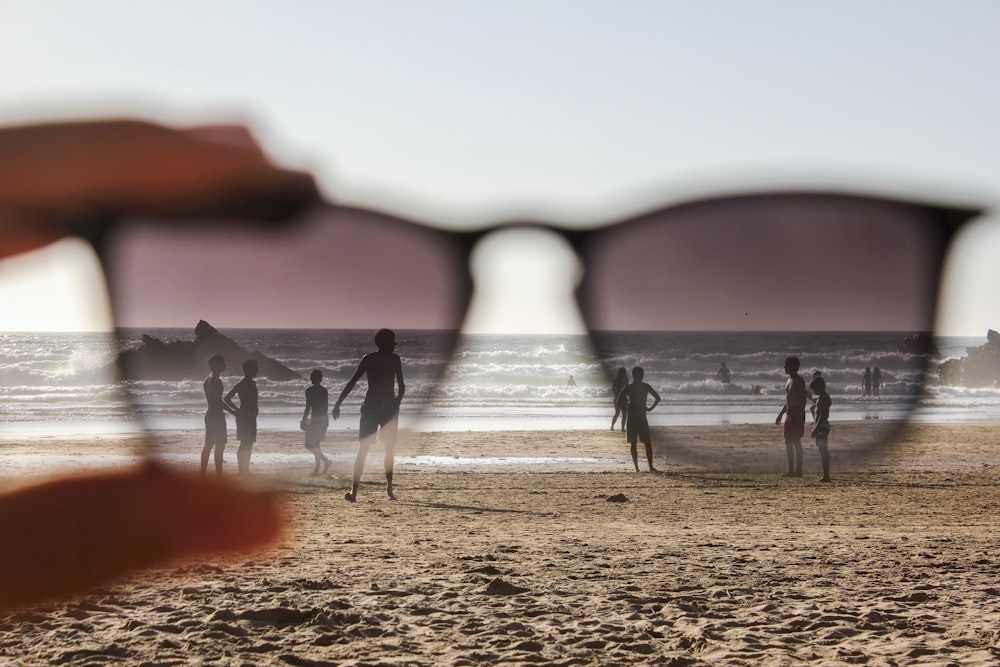 people on beach during sunset