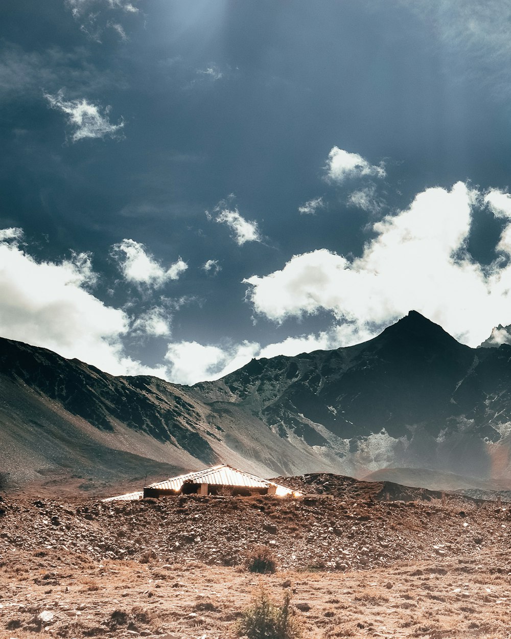 brown and green mountain under white clouds and blue sky during daytime