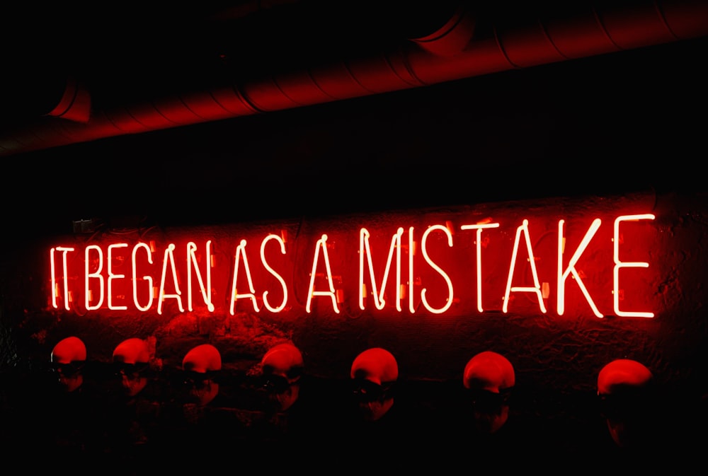 a neon sign that says itbegan as a mistake