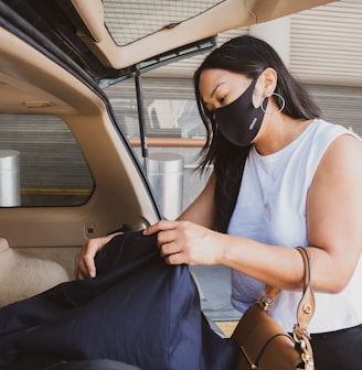 woman in white tank top wearing black sunglasses holding blue textile