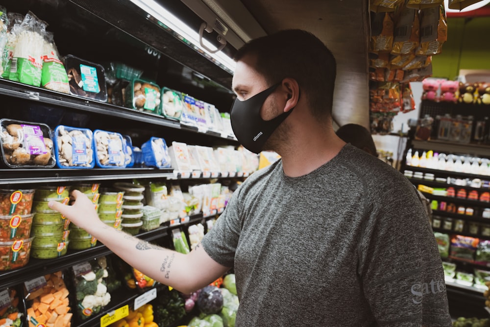 man in gray crew neck shirt wearing black sunglasses