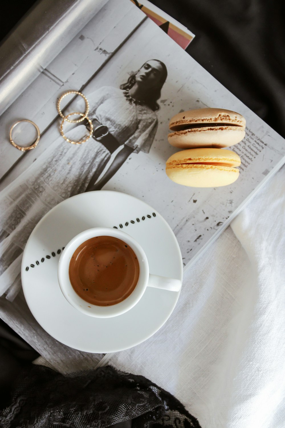 white ceramic cup on white ceramic saucer beside brown bread