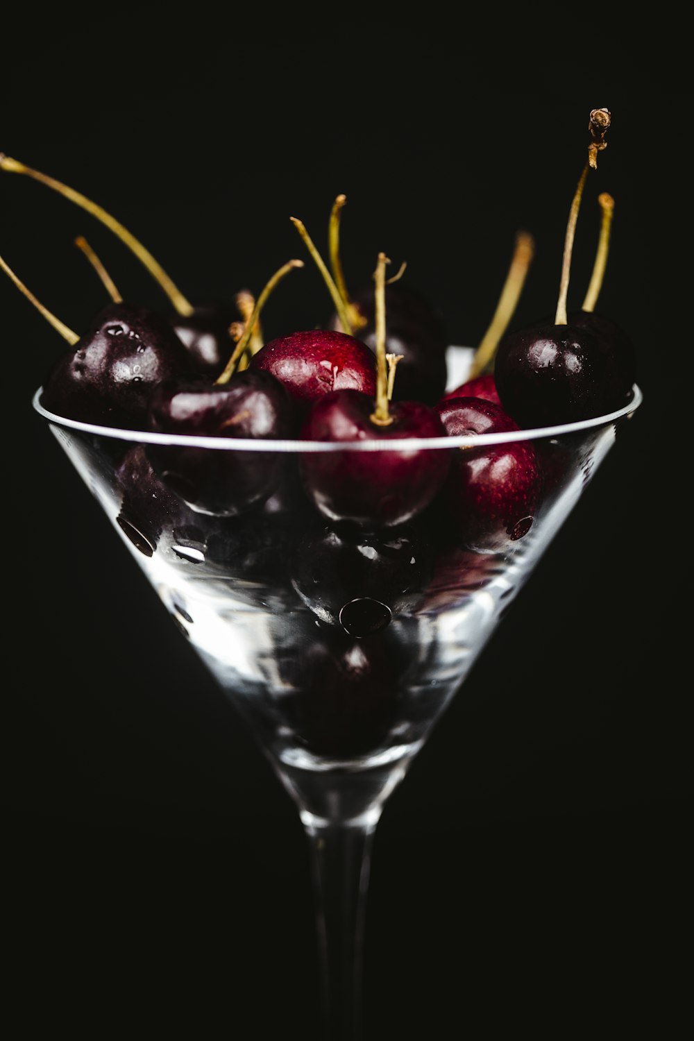 red cherries in clear glass