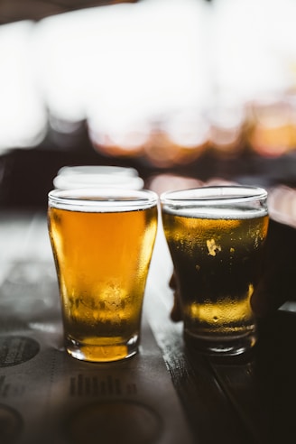 clear drinking glass with beer on black table