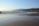 A serene landscape with gentle waves and soft light.