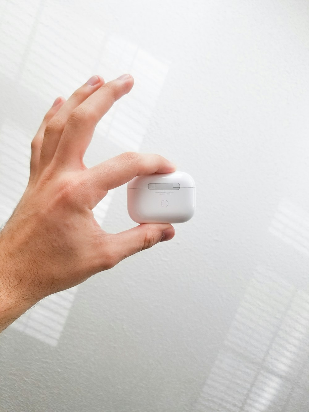 person holding white apple charger