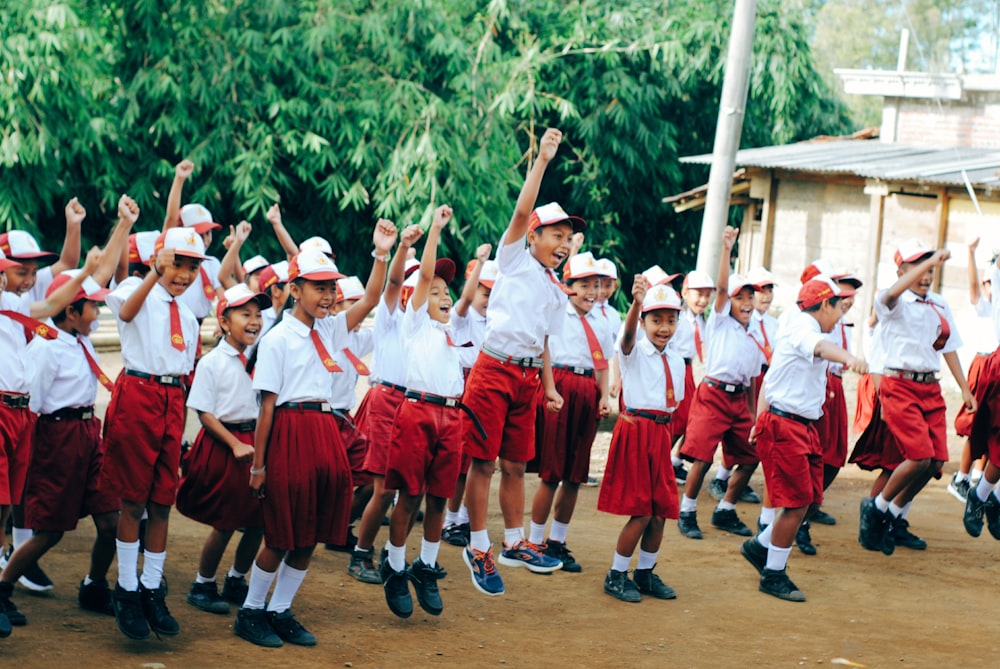 group of people in red and white uniform holding hands