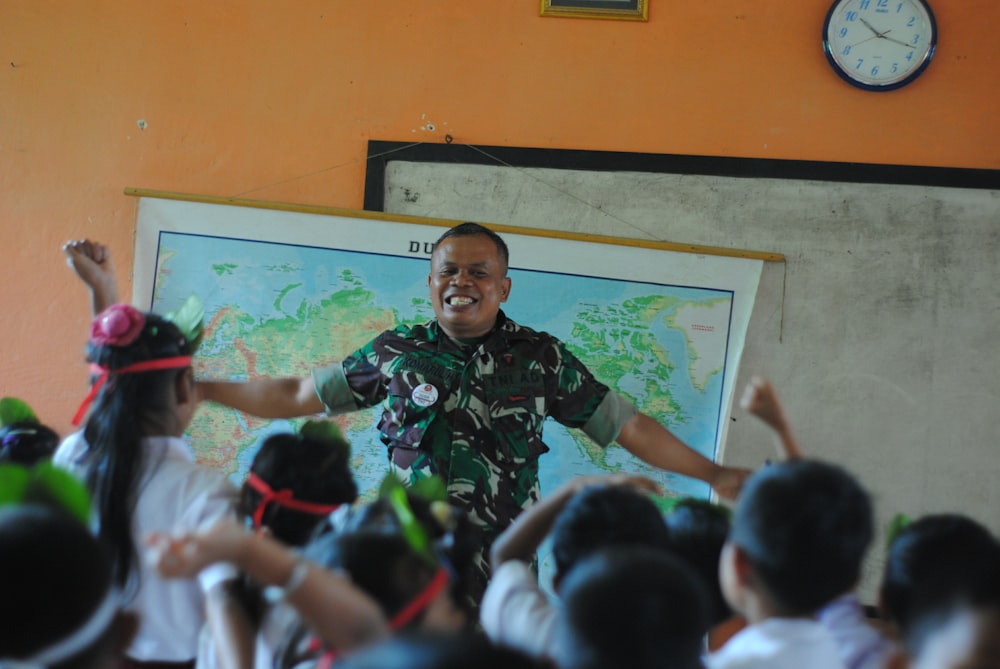 man in black and green camouflage jacket standing in front of people