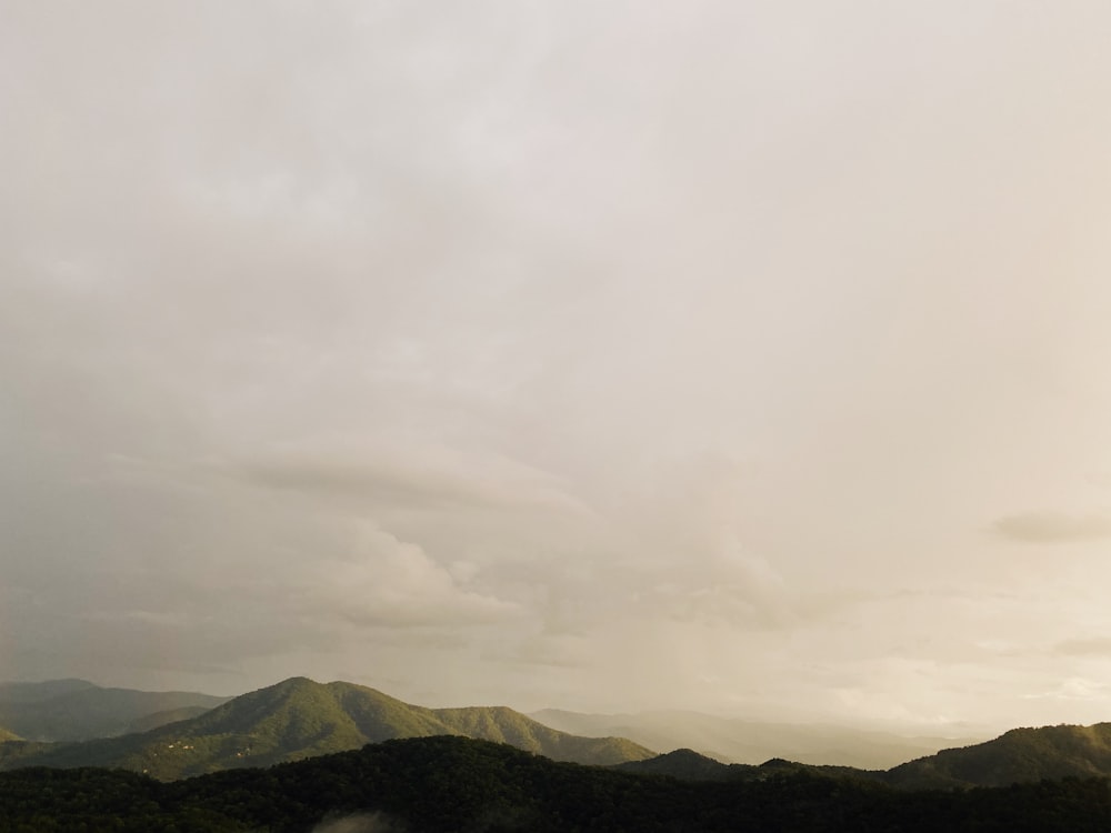 green mountains under white clouds during daytime