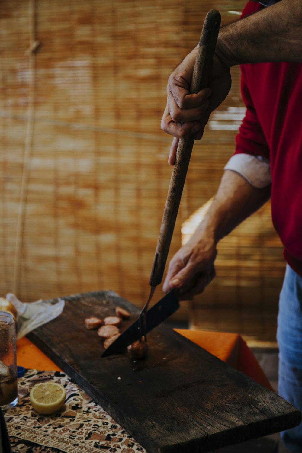 person holding knife slicing meat