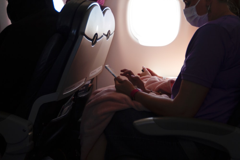 person in blue t-shirt sitting on black chair