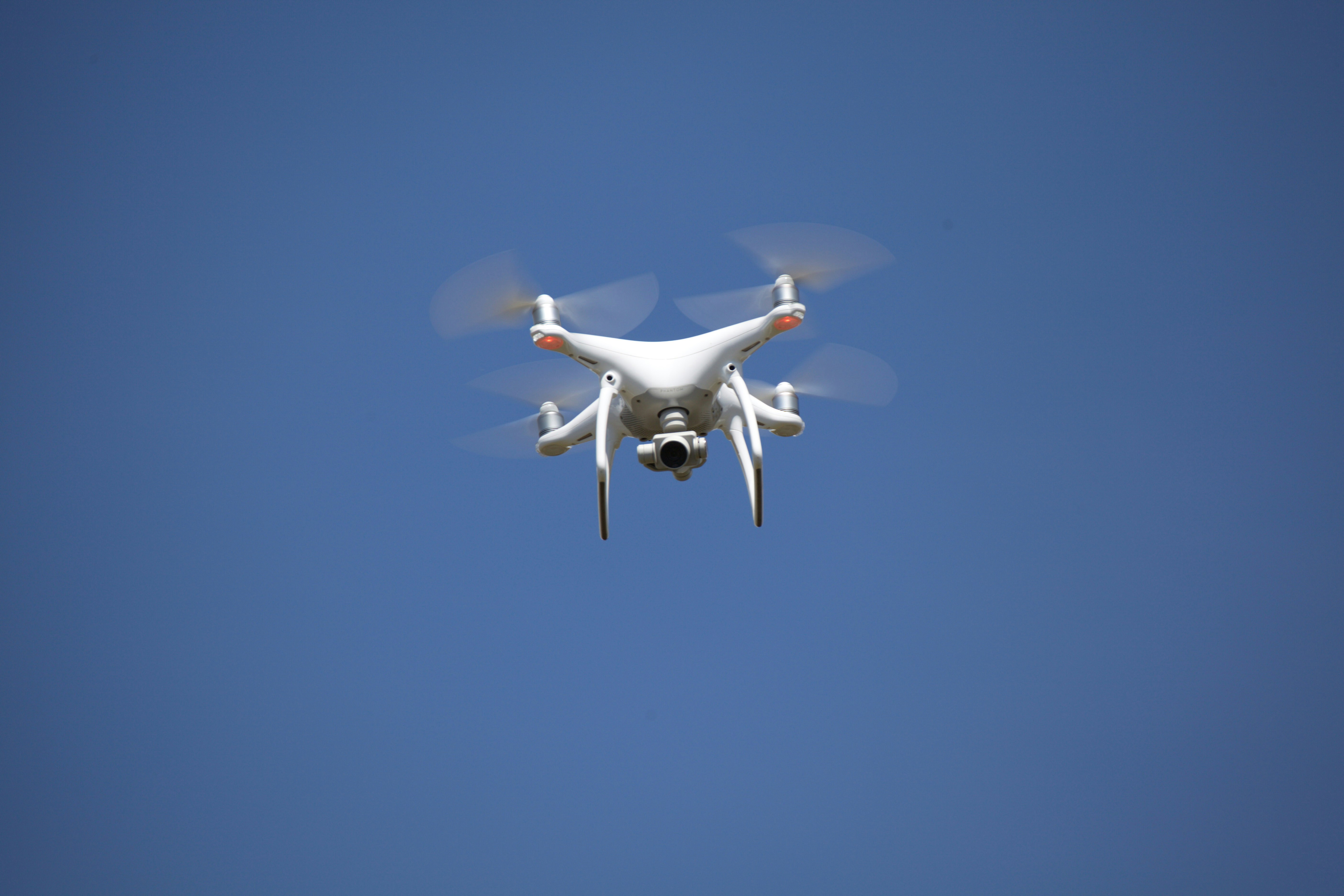 white airplane flying in the sky