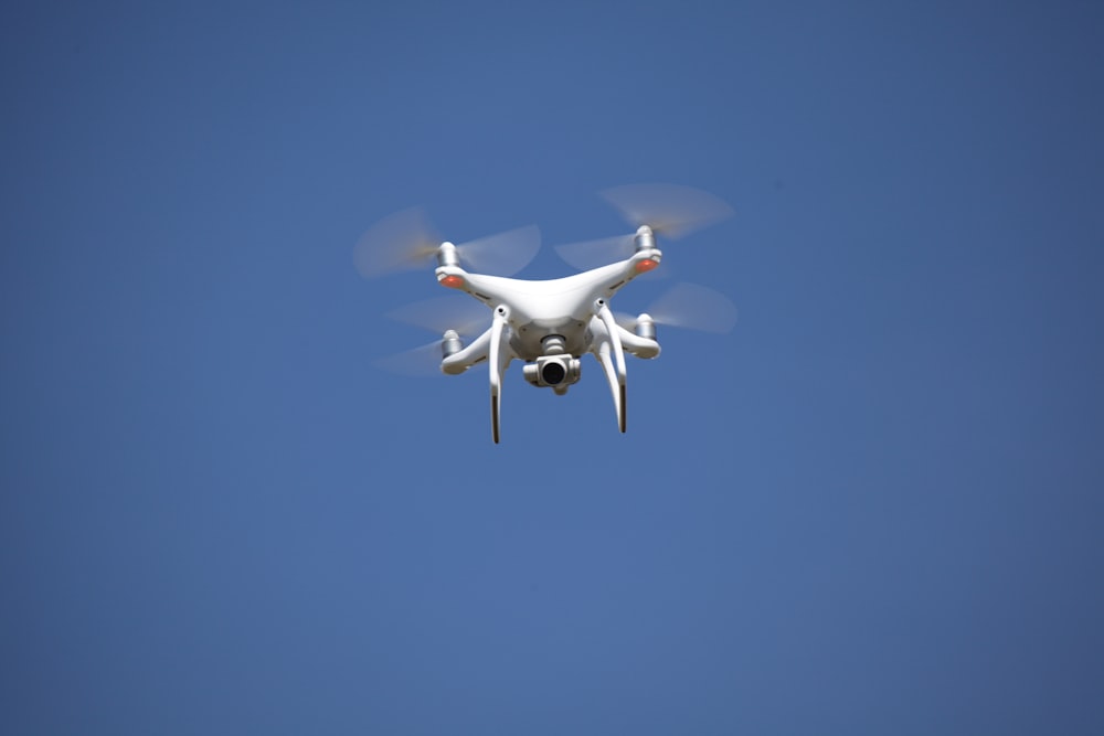 white airplane flying in the sky