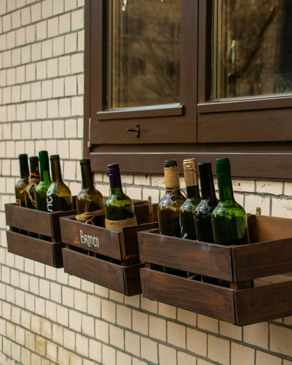 green glass bottles on brown wooden shelf