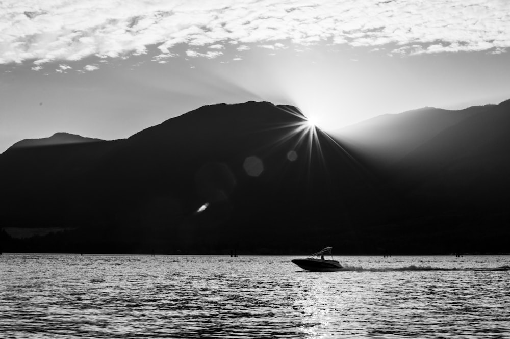 grayscale photo of boat on sea