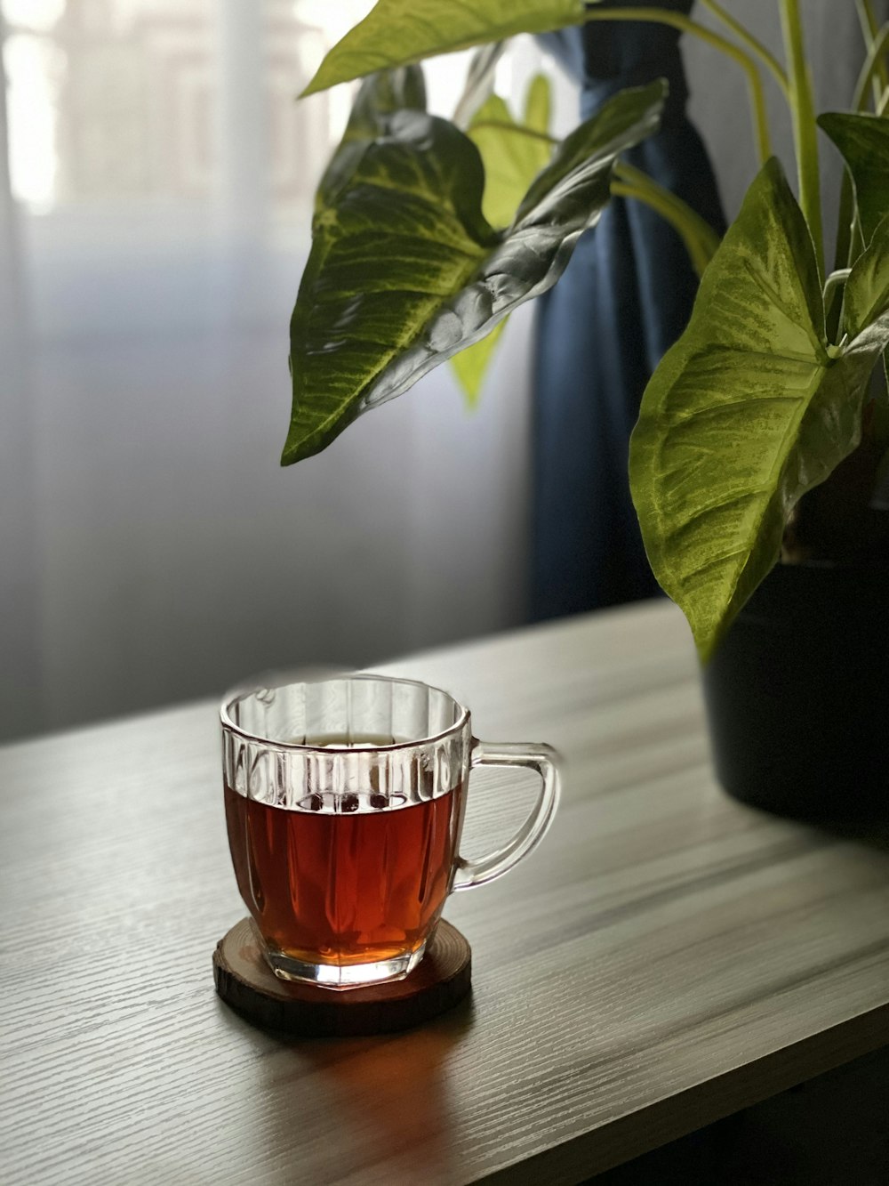 clear glass mug with brown liquid inside