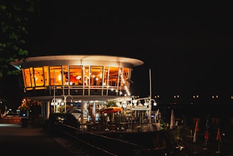 Evening view of the jgolf clubhaus illuminated warmly from inside.