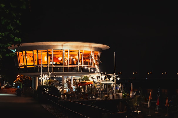 Evening view of the jgolf clubhaus illuminated warmly from inside.