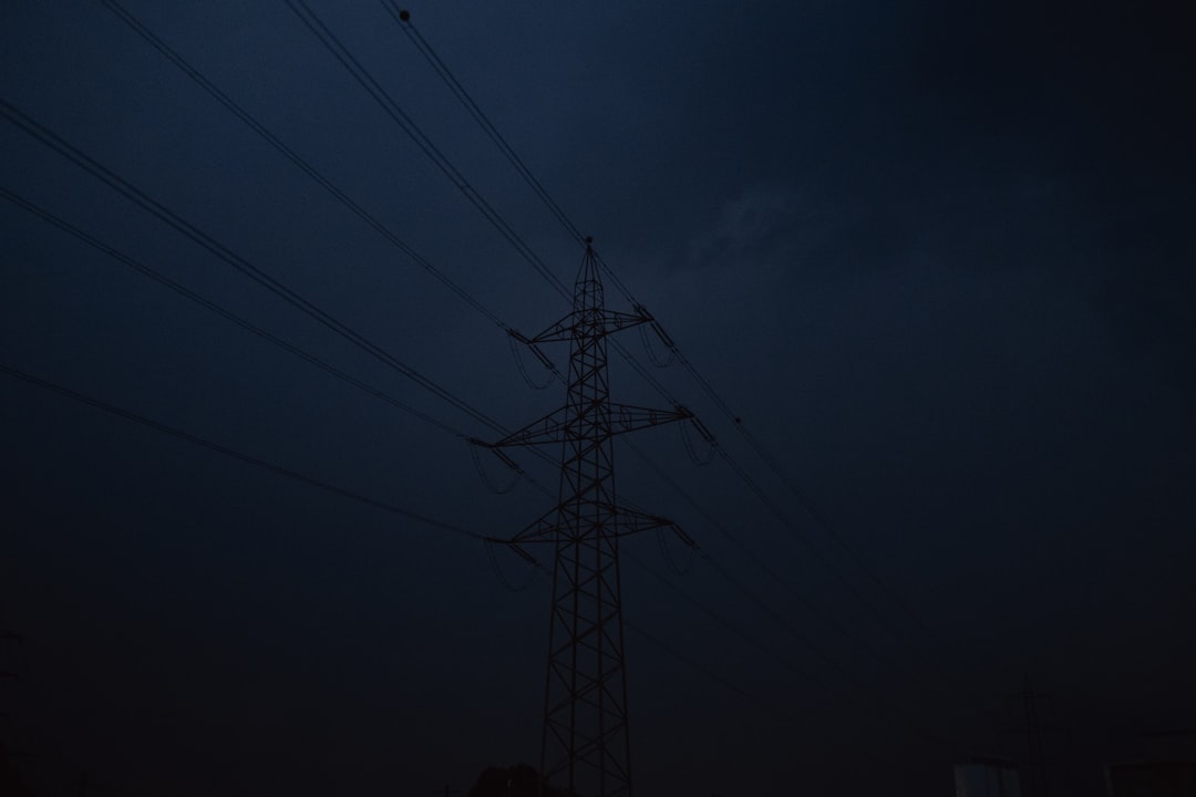 black electric tower under dark sky